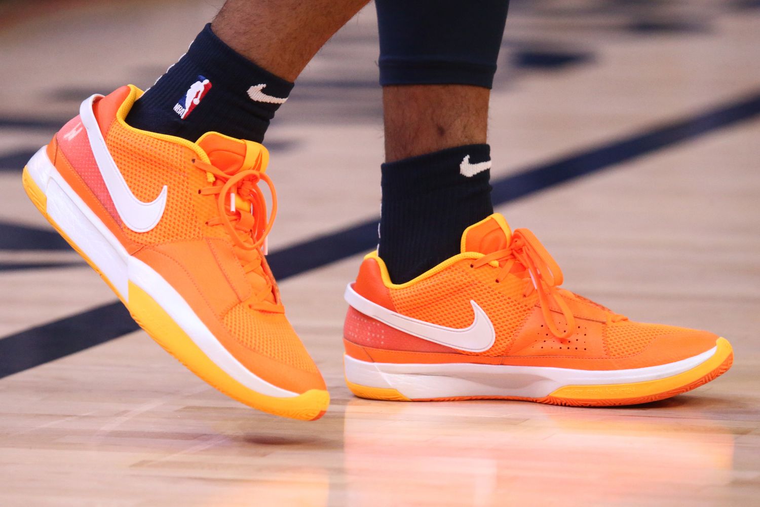 Memphis Grizzlies guard Ja Morant's orange and white Nike sneakers.